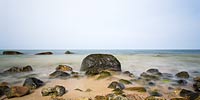  Steine in verschiedenen Größen im Uferbereich vor Dänisch-Nienhof an einem Tag im Sommer